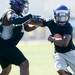 Pioneer's Bashir Garain runs the ball during a morning practice at Pioneer High School on Monday. Melanie Maxwell I AnnArbor.com
